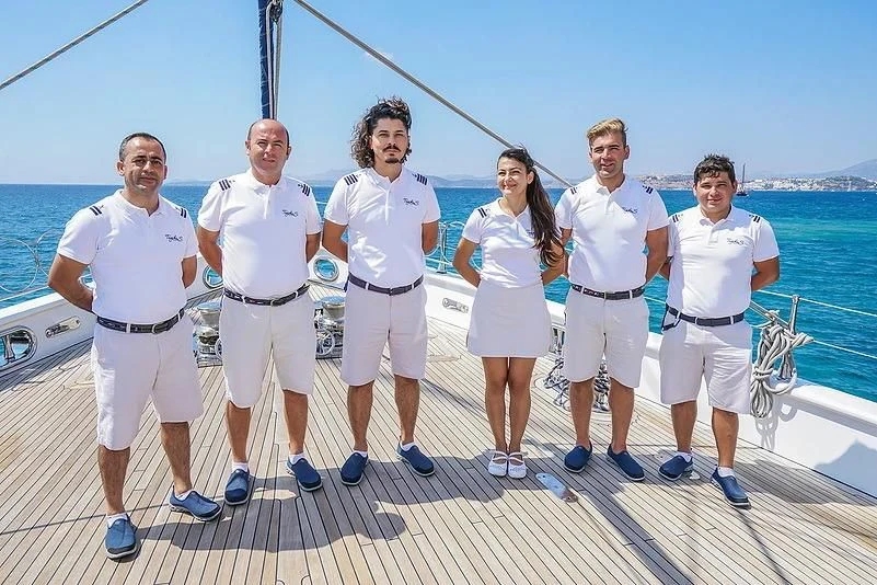 a group of people posing for a photo on a boat aboard TUYIKA S Yacht for Sale