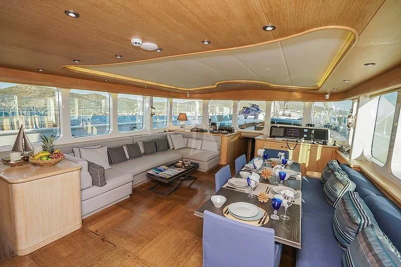 a living room with a large window aboard TUYIKA S Yacht for Sale