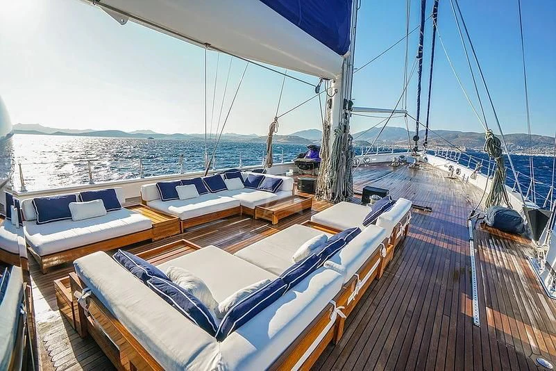 a deck with lounge chairs on it aboard TUYIKA S Yacht for Sale