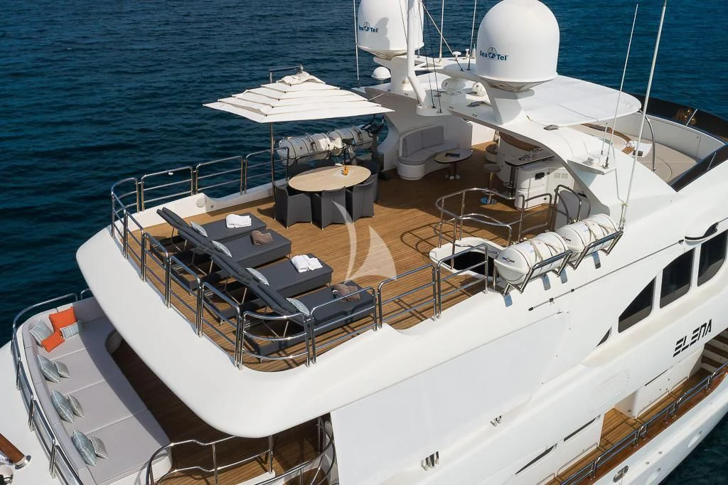 a boat with a table and umbrella on it aboard ELENA NUEVE Yacht for Charter