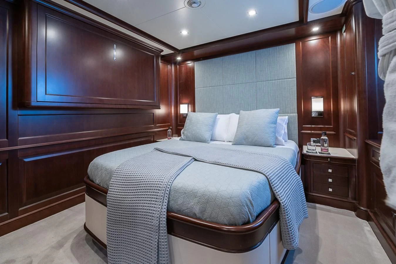 a bed with a white sheet and pillows aboard ELENA NUEVE Yacht for Charter