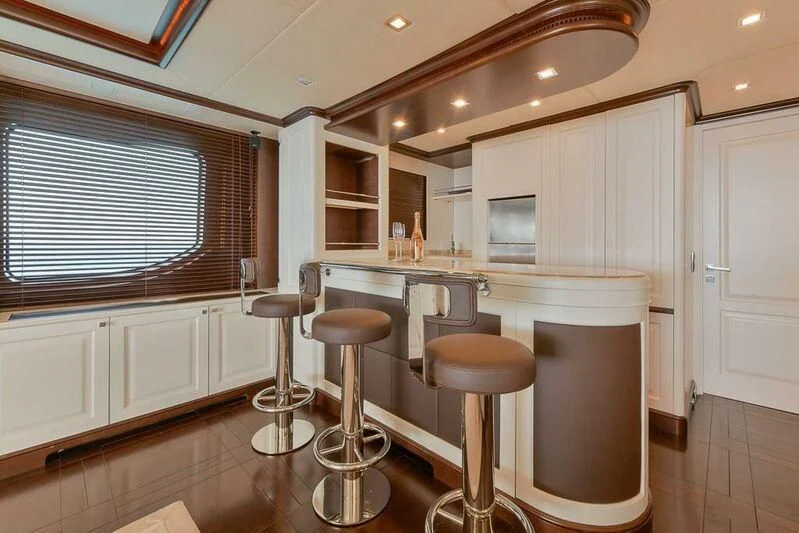 a kitchen with stools and a bar stool aboard ELENA NUEVE Yacht for Charter