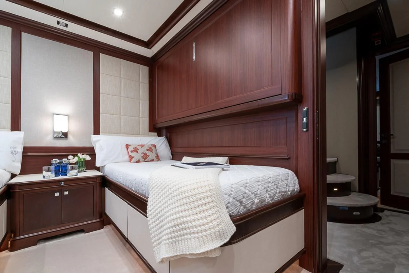 a bed with a white sheet on it aboard ELENA NUEVE Yacht for Charter