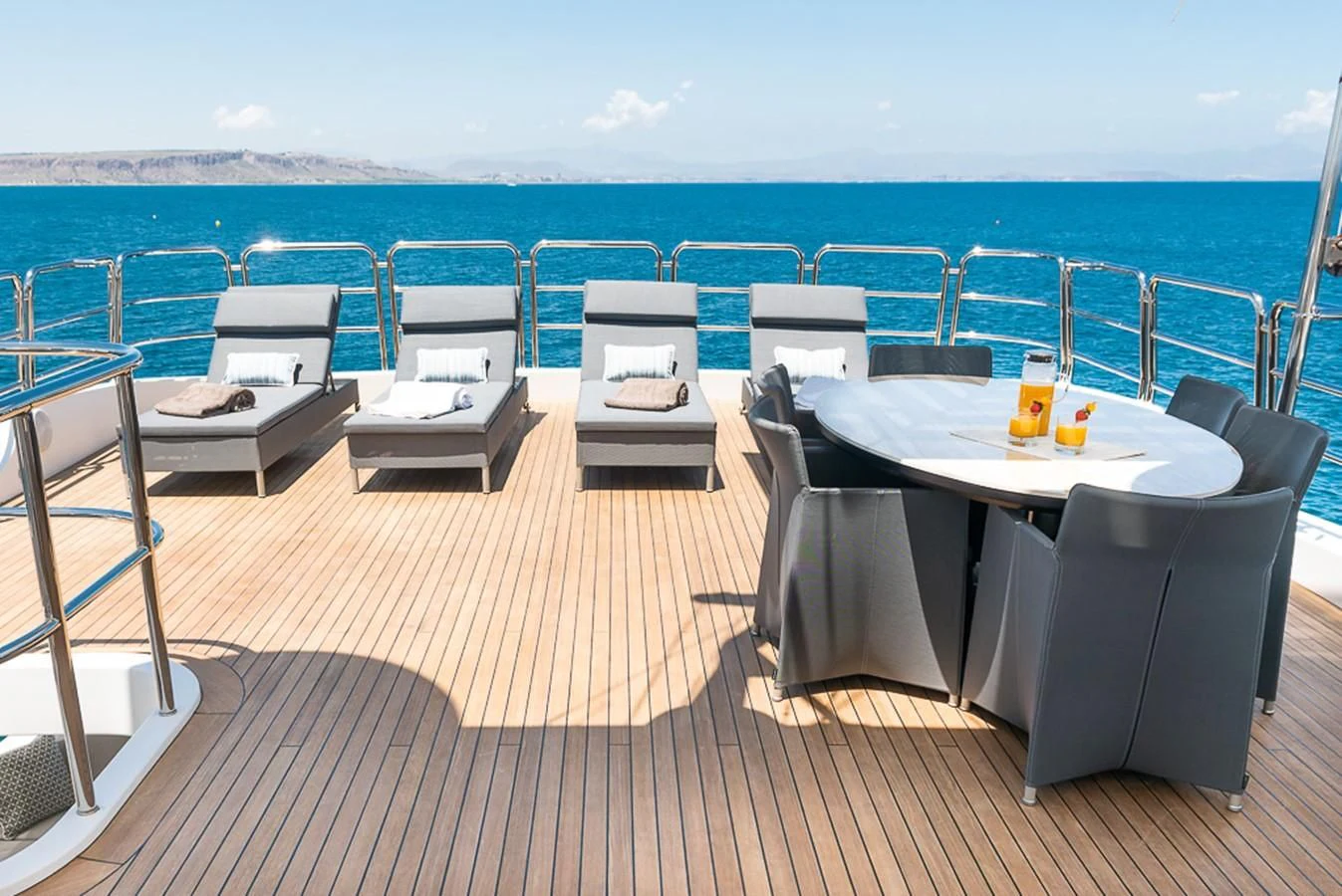 a deck with chairs and tables on it aboard ELENA NUEVE Yacht for Charter