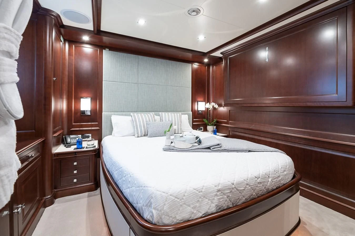 a bed with a white sheet and a white bed spread aboard ELENA NUEVE Yacht for Charter