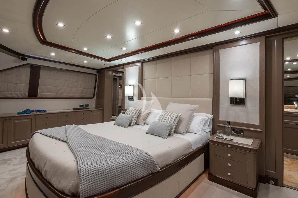 a bedroom with a bed and a desk aboard ELENA NUEVE Yacht for Charter