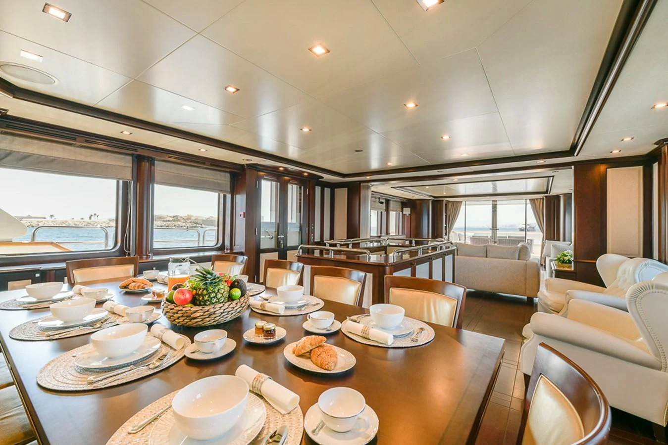 a large kitchen with a table set aboard ELENA NUEVE Yacht for Charter