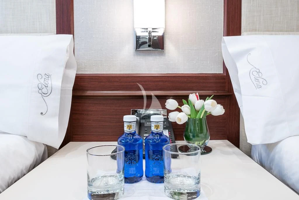 a table with a bottle and glasses aboard ELENA NUEVE Yacht for Charter