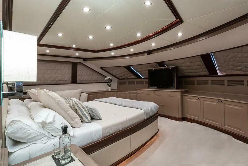 a bed with a white bed aboard ELENA NUEVE Yacht for Charter