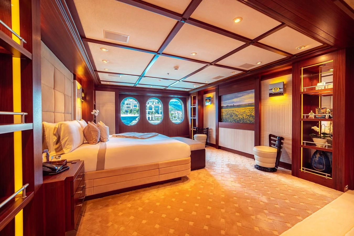 a bedroom with a bed and a bookcase aboard TRIDENT Yacht for Charter