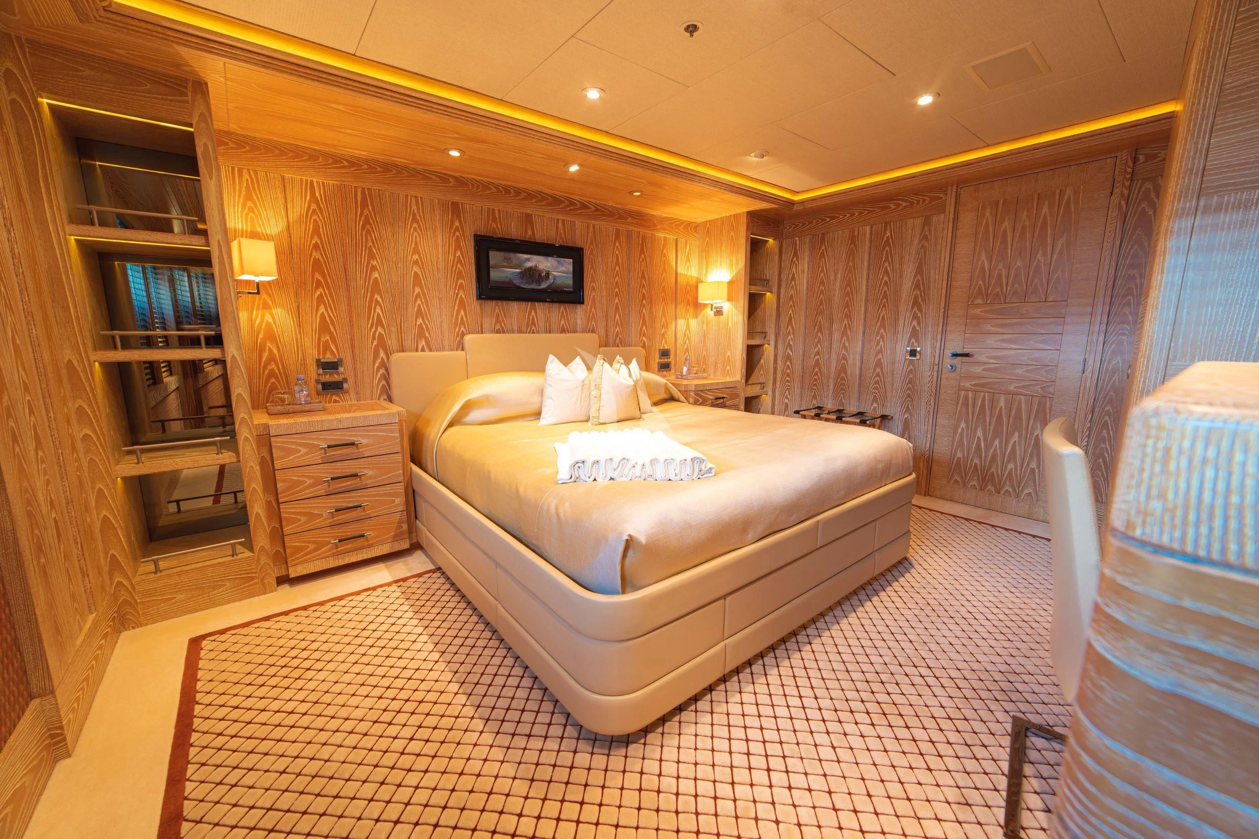 a room with a bed and a chair aboard TRIDENT Yacht for Charter