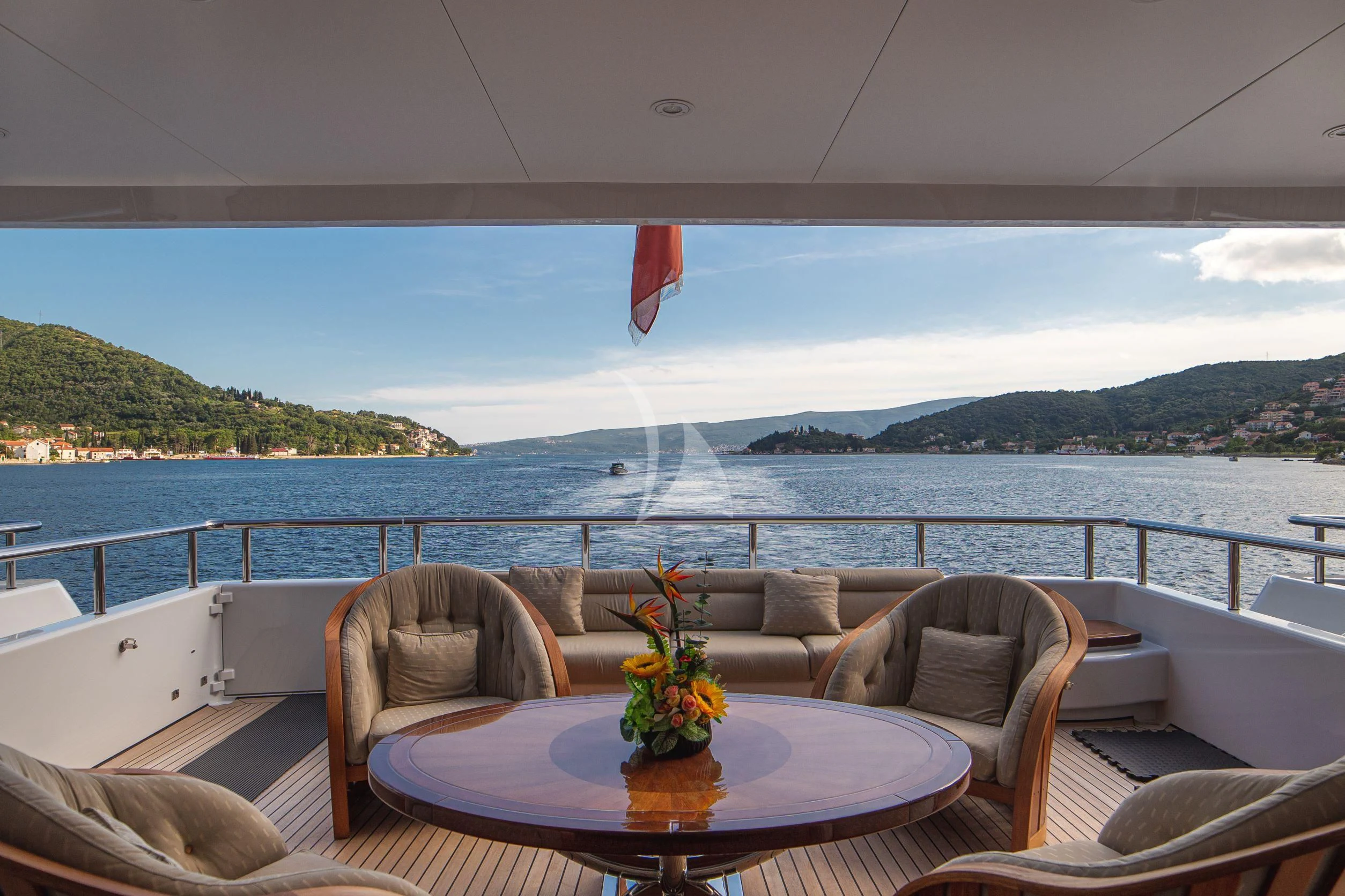 a table with a flower on it aboard TRIDENT Yacht for Charter