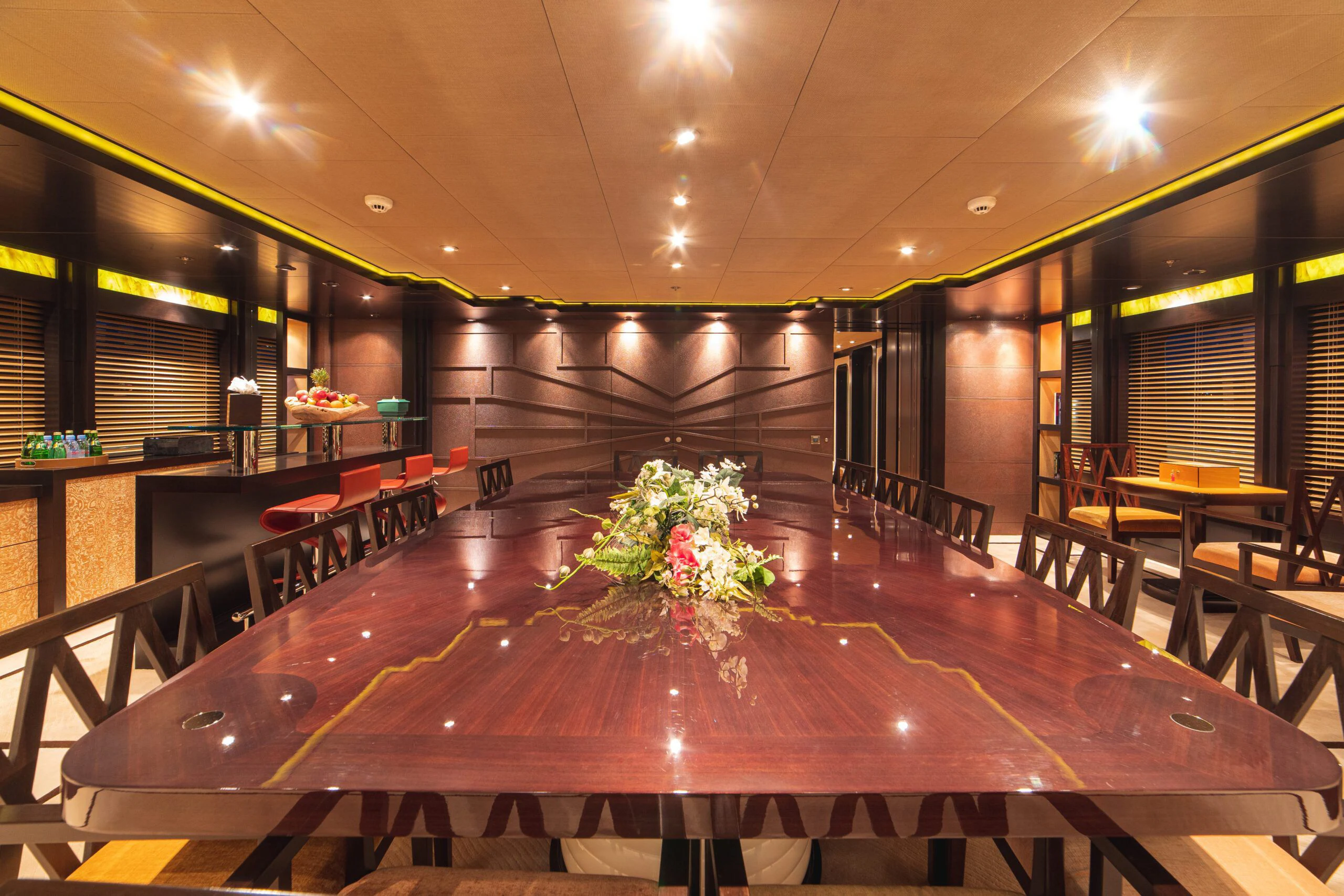a large room with tables and chairs aboard TRIDENT Yacht for Charter