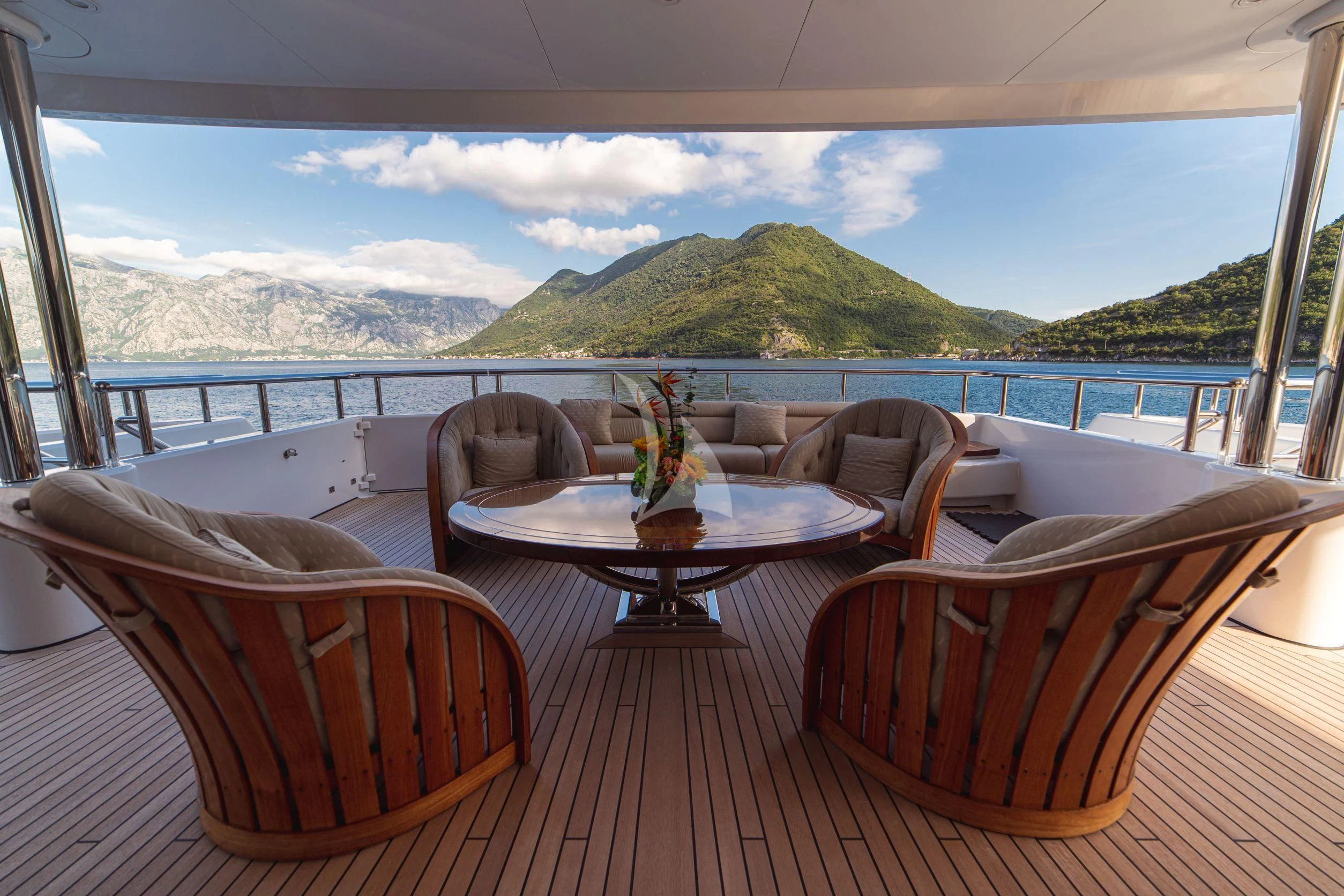 a table and chairs on a balcony aboard TRIDENT Yacht for Charter