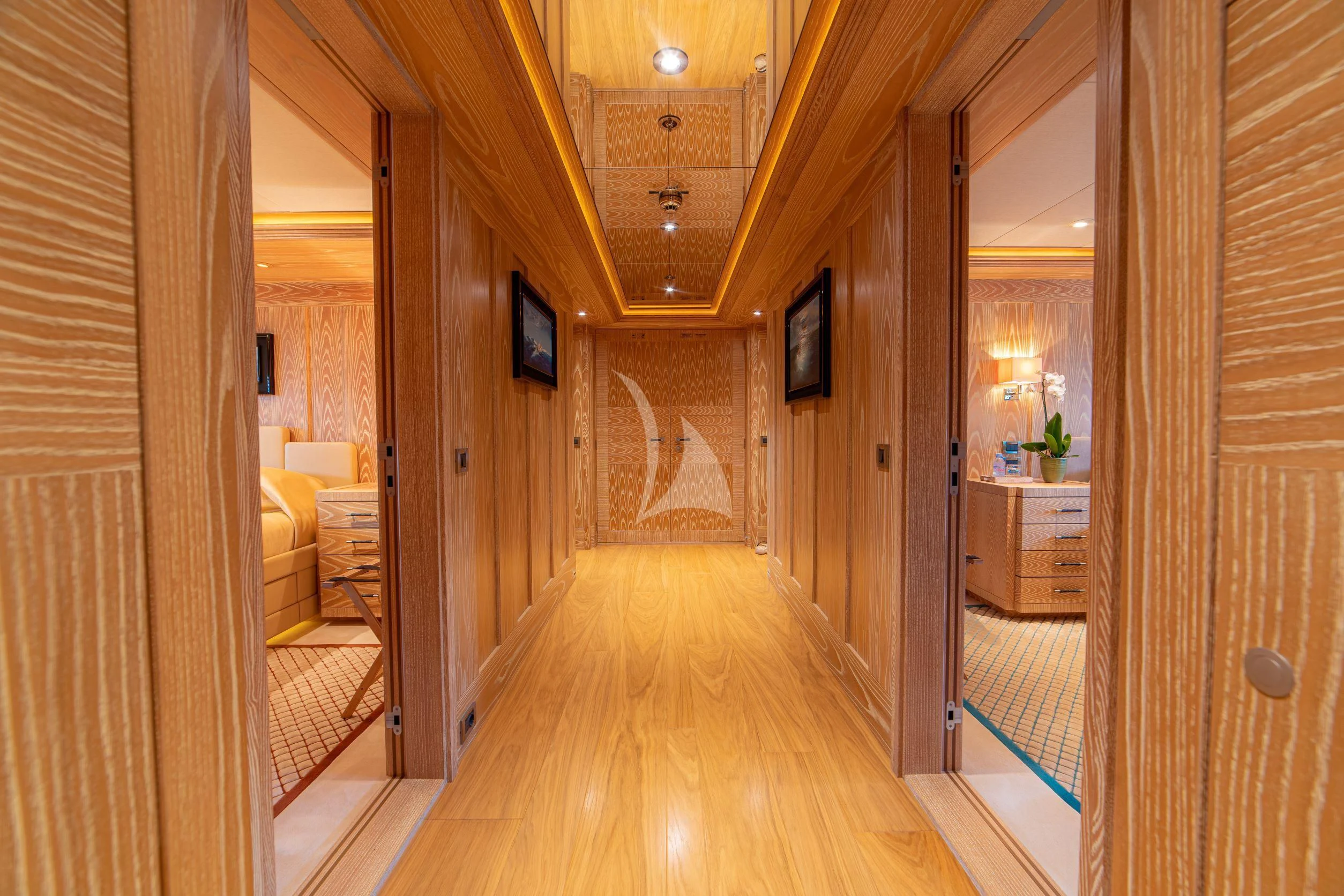 a hallway with a wood floor and a wood door aboard TRIDENT Yacht for Charter
