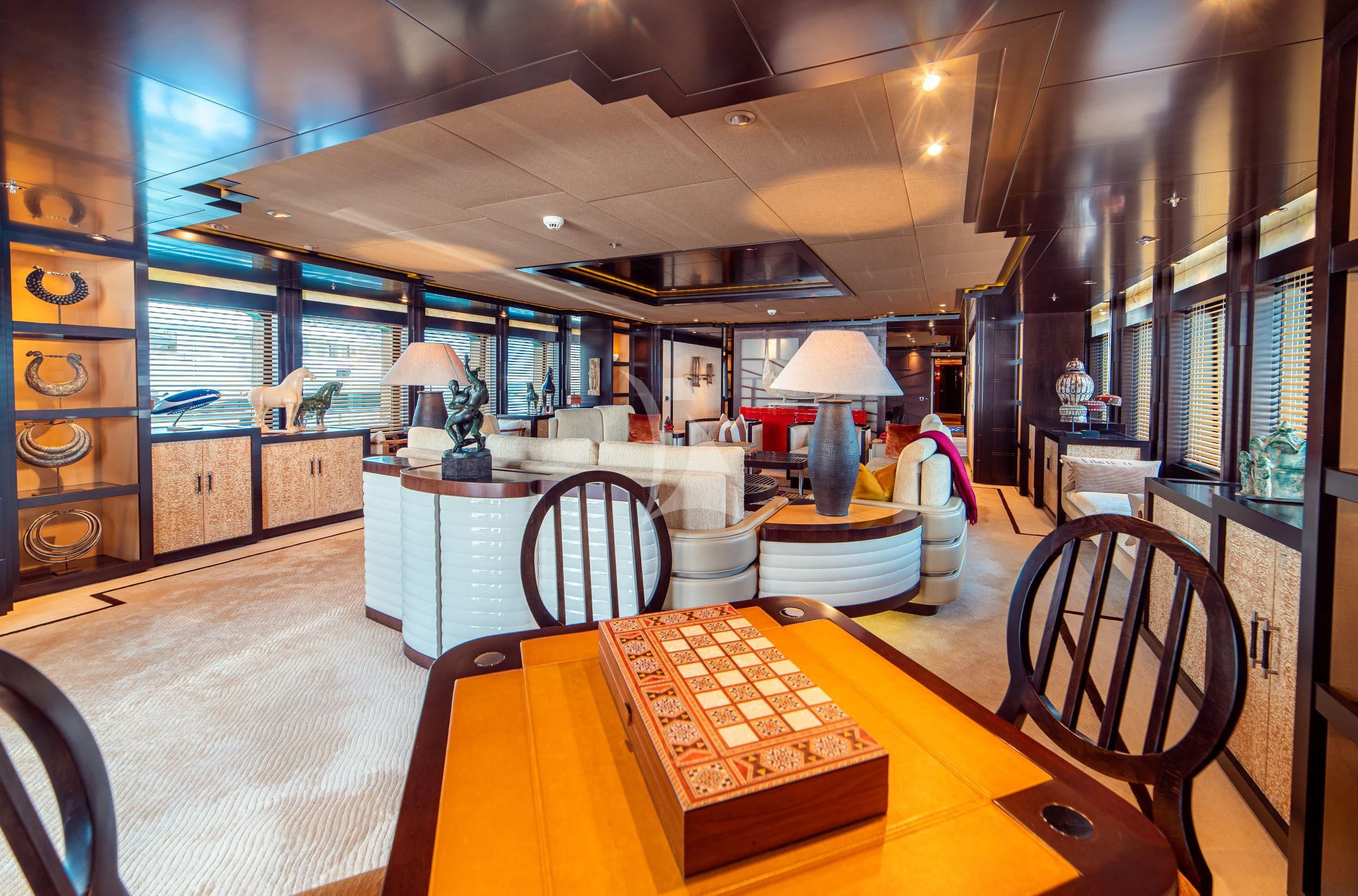 a large room with a table and chairs aboard TRIDENT Yacht for Charter