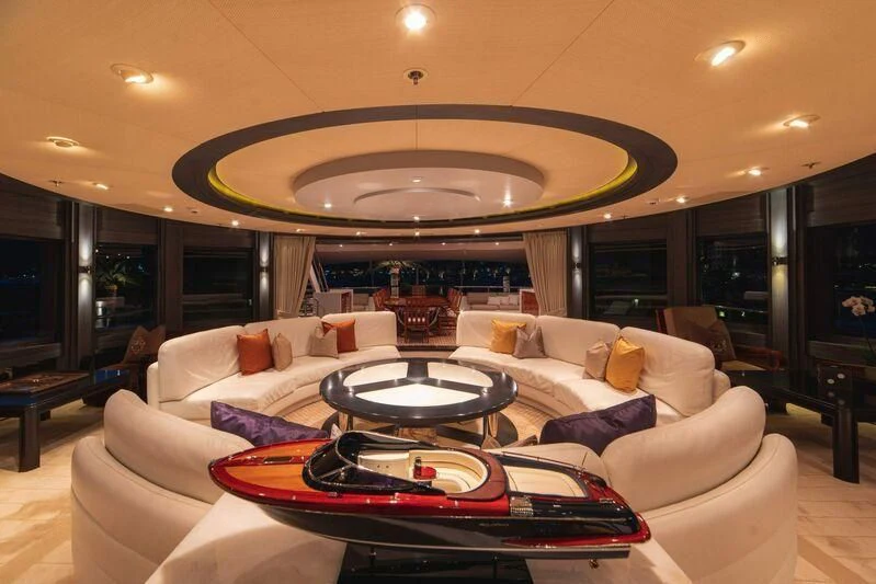 a living room with a large chandelier aboard TRIDENT Yacht for Charter