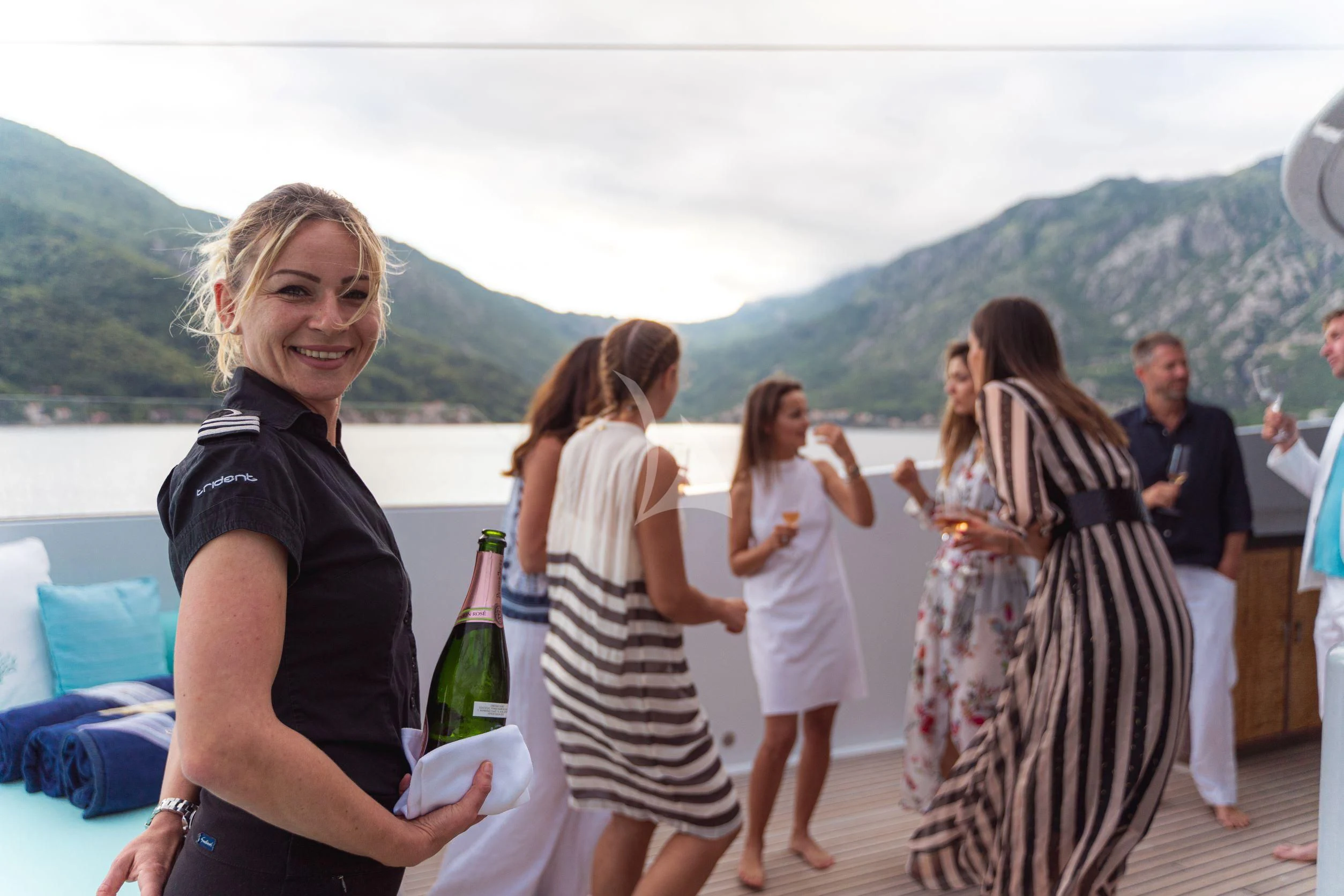 a person holding a bottle of wine aboard TRIDENT Yacht for Charter