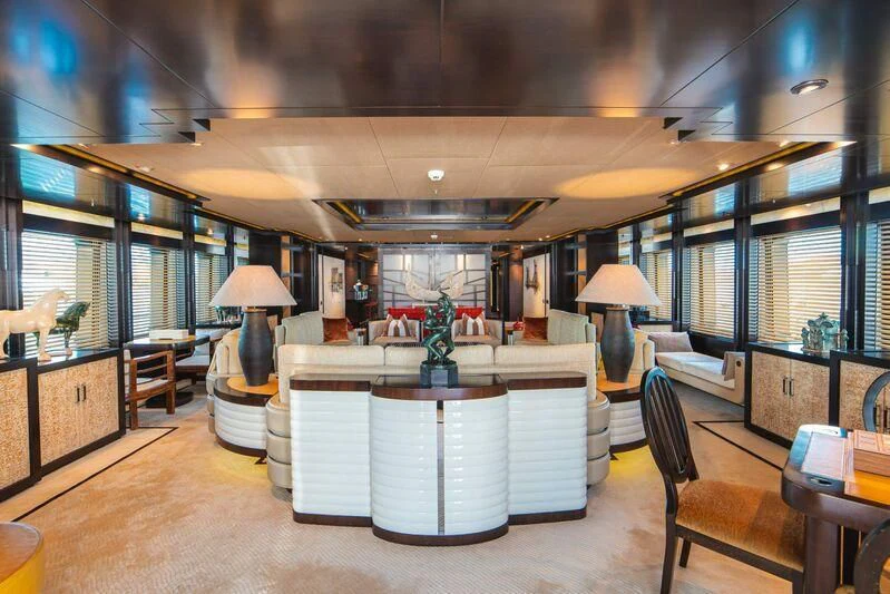 a large room with a large white table and chairs aboard TRIDENT Yacht for Charter