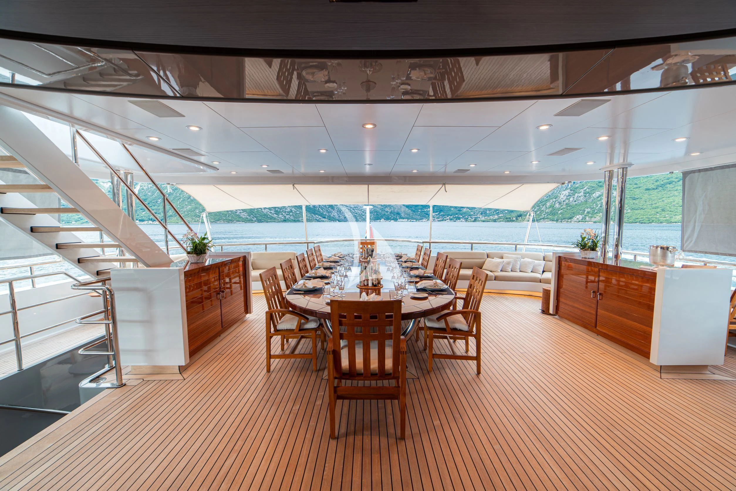 a large room with a table and chairs aboard TRIDENT Yacht for Charter