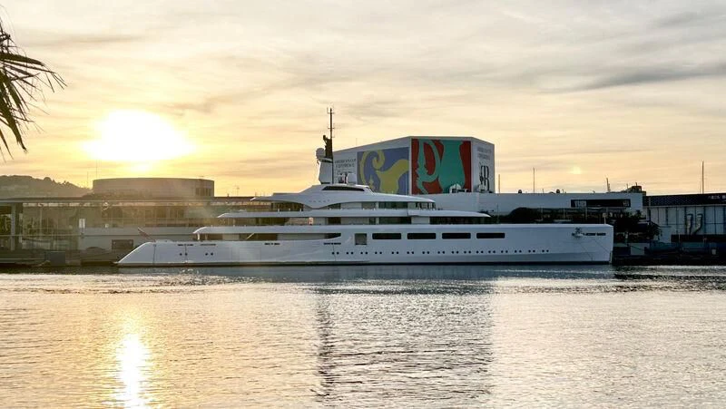 a large white boat in a harbor aboard VAVA II Yacht for Sale