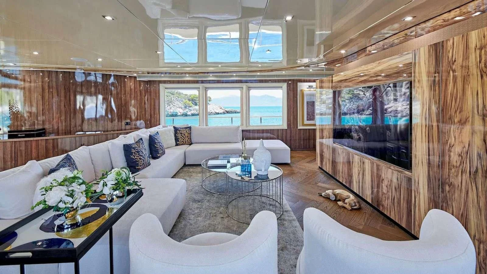 a living room with a large window aboard PROMETHEUS I Yacht for Charter