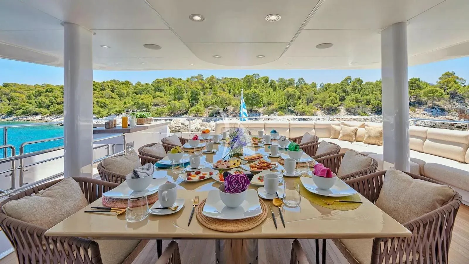 a table with plates and cups on it aboard PROMETHEUS I Yacht for Charter