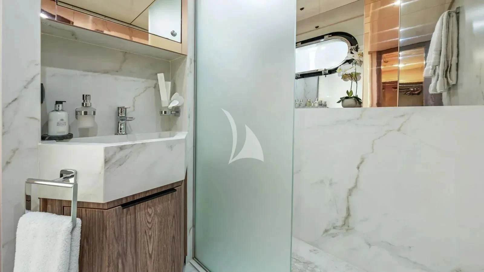 a bathroom with a sink and a mirror aboard PROMETHEUS I Yacht for Charter