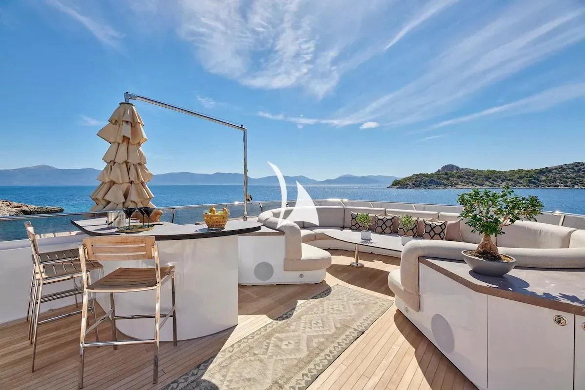 a table and chairs on a balcony aboard PROMETHEUS I Yacht for Charter