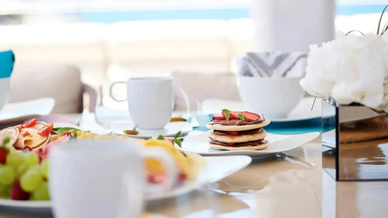 a plate of desserts on a table aboard PROMETHEUS I Yacht for Charter