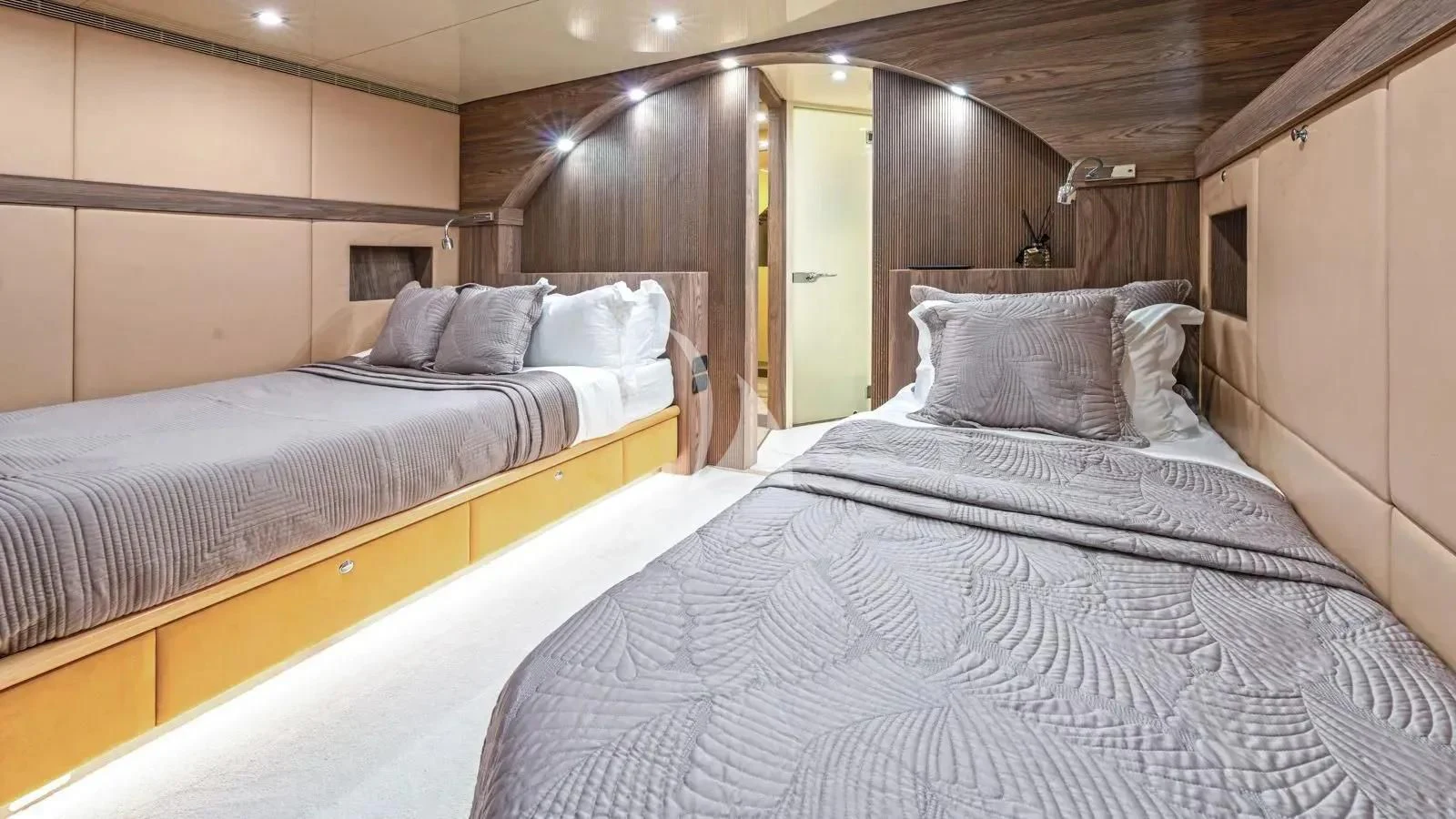 a room with beds and a mirror aboard PROMETHEUS I Yacht for Charter