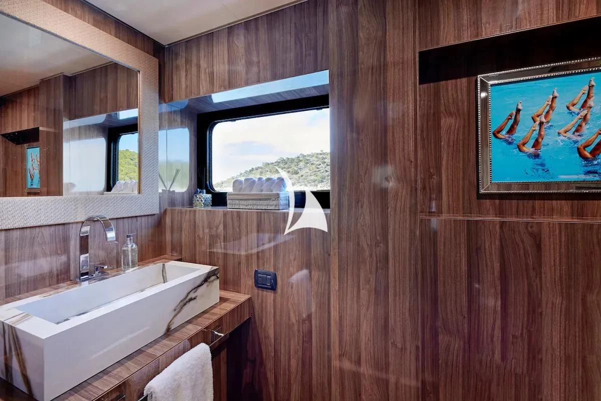 a bathroom with a wood wall aboard PROMETHEUS I Yacht for Charter