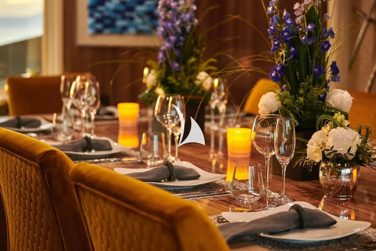 a table with glasses and plates aboard PROMETHEUS I Yacht for Charter