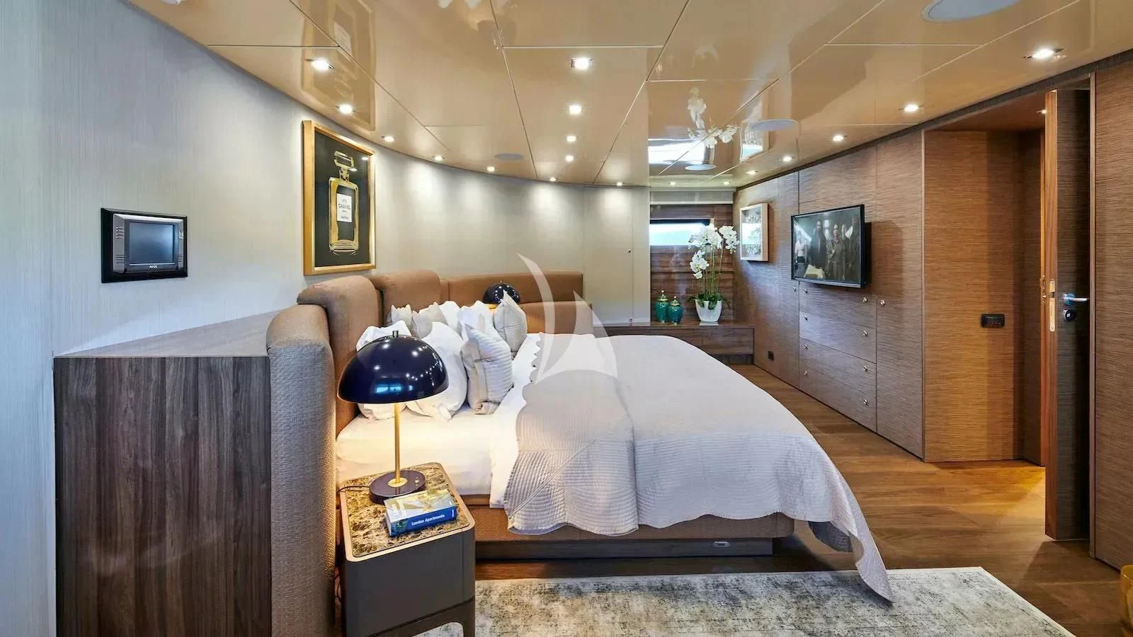 a bedroom with a bed and a television aboard PROMETHEUS I Yacht for Charter