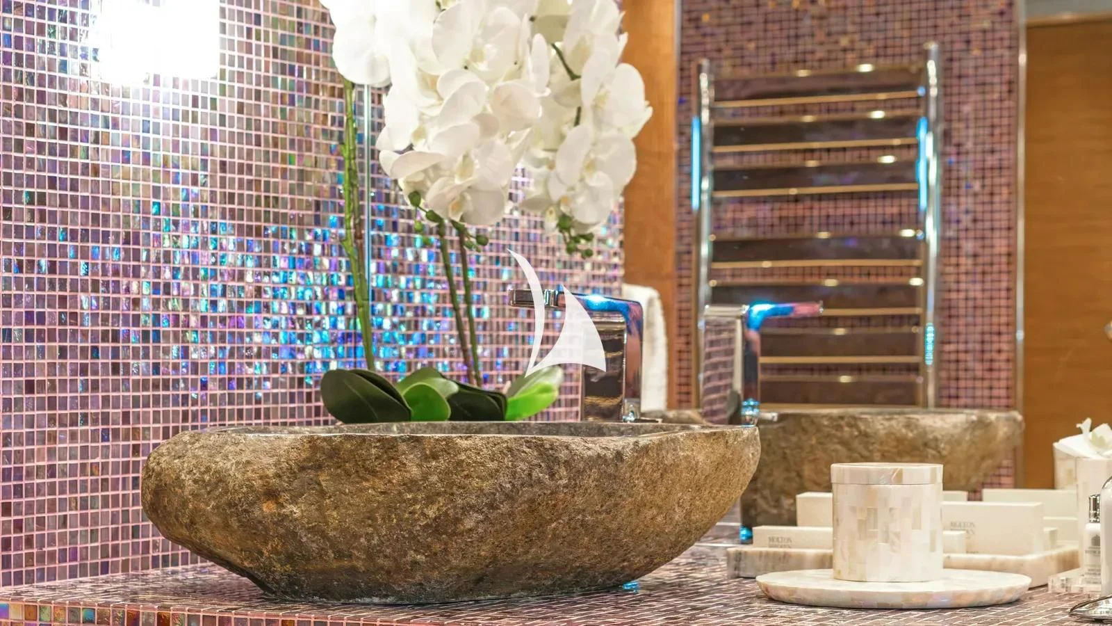 a stone wall with white flowers aboard PROMETHEUS I Yacht for Charter