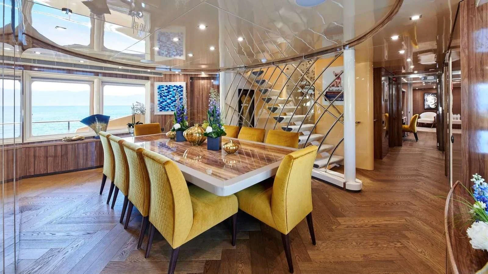 a room with a table and chairs aboard PROMETHEUS I Yacht for Charter