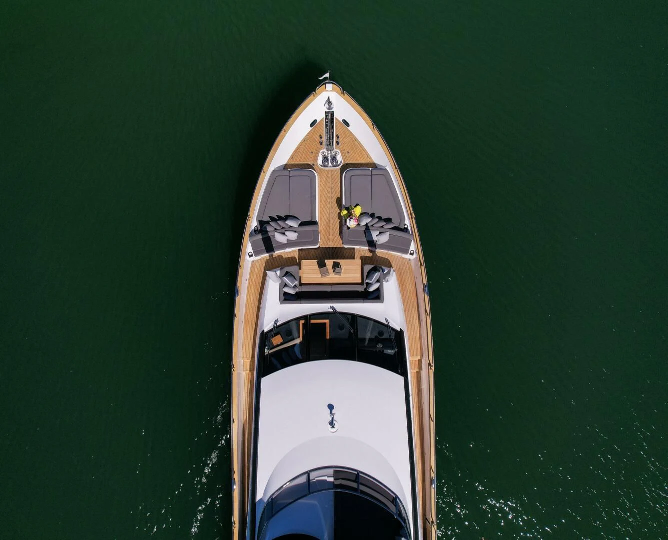 a white and gold boat on water aboard EBRA Yacht for Sale