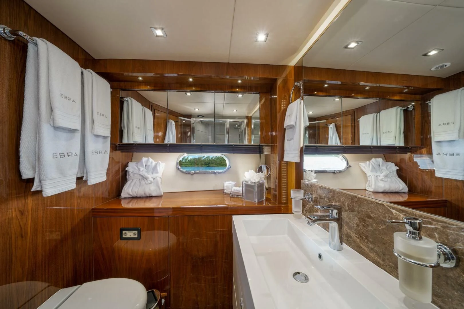 a bathroom with a large mirror aboard EBRA Yacht for Sale