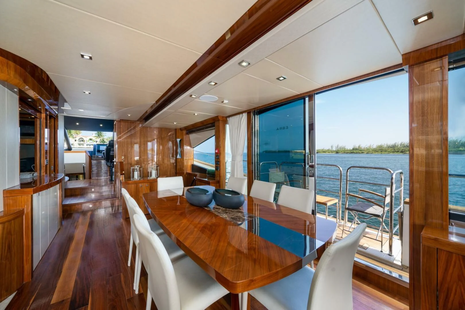 a large room with a table and chairs aboard EBRA Yacht for Sale