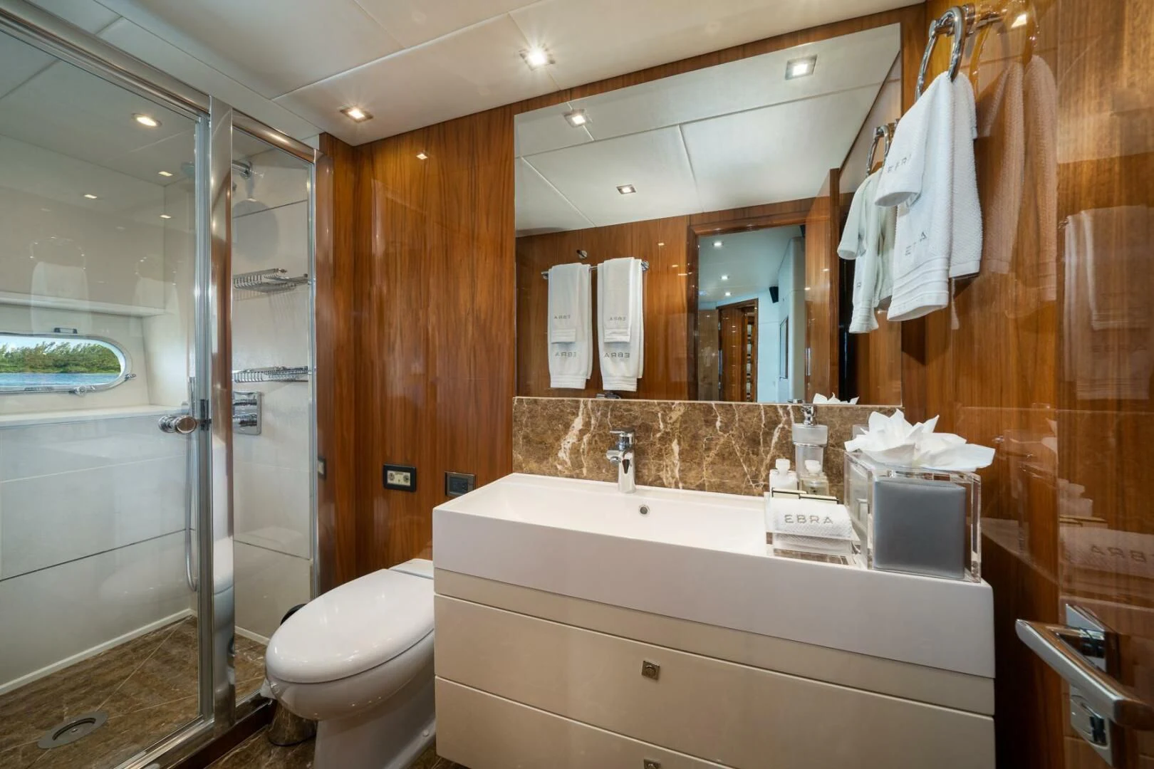 a bathroom with a glass shower aboard EBRA Yacht for Sale