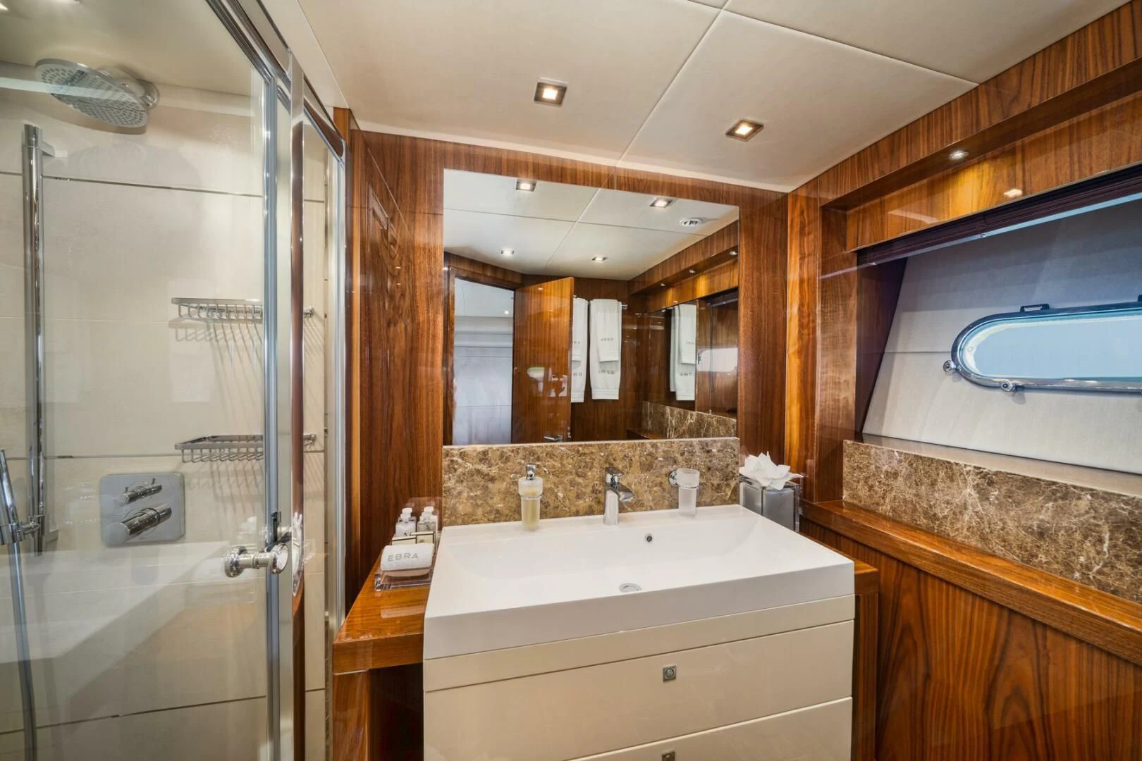 a bathroom with a glass shower aboard EBRA Yacht for Sale