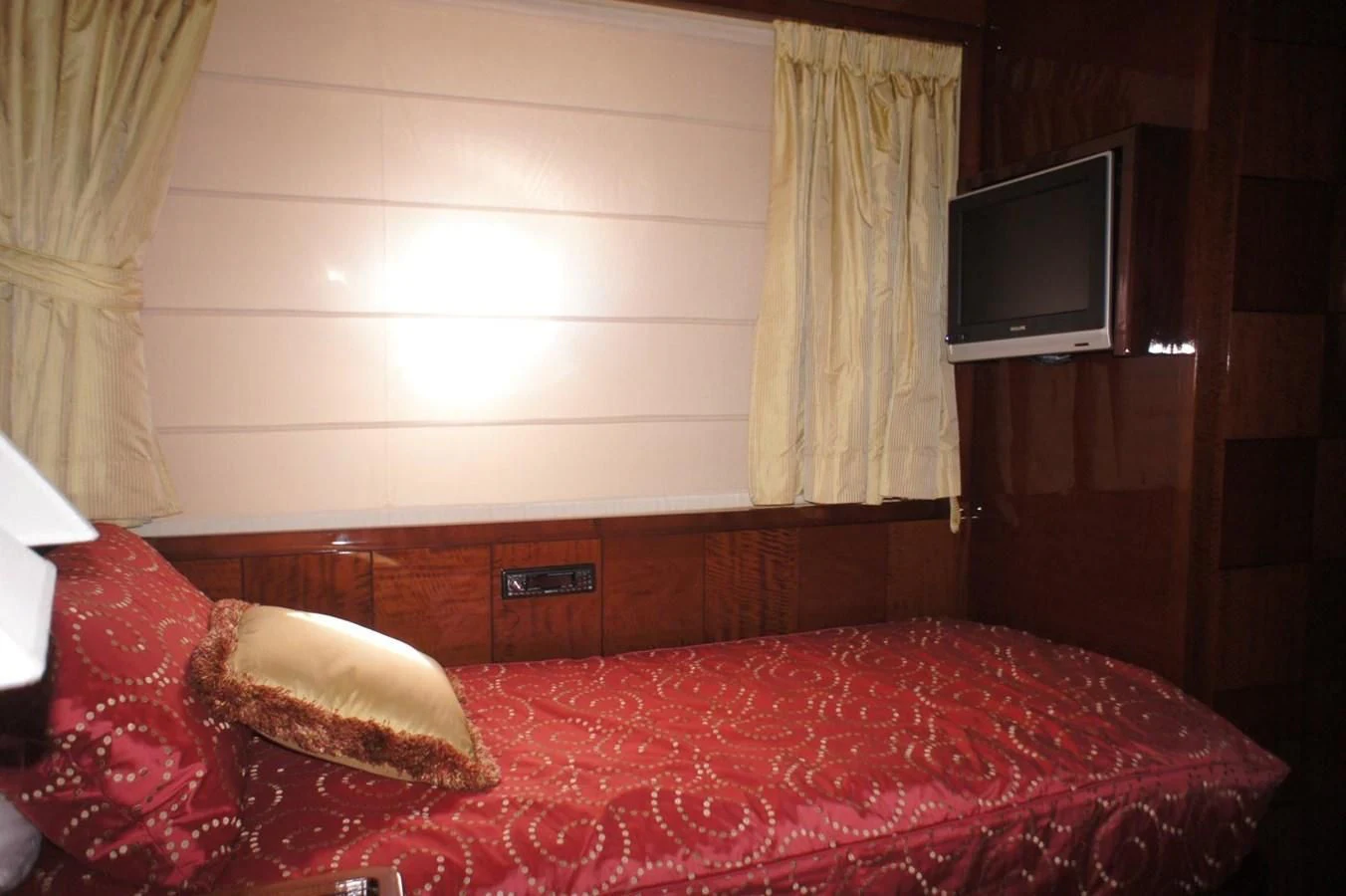 a room with a bed and a television aboard CASPIAN Yacht for Sale