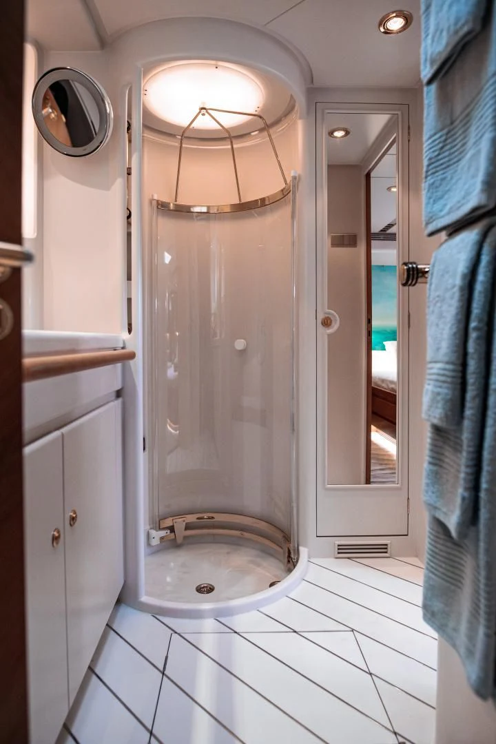 a shower unit in a bathroom aboard SCARENA Yacht for Charter