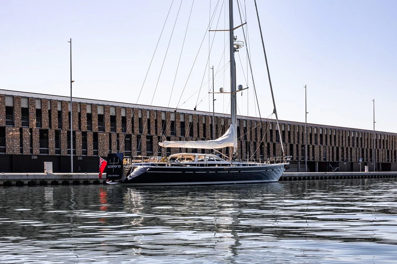 a boat docked in front of a building aboard SCARENA Yacht for Charter