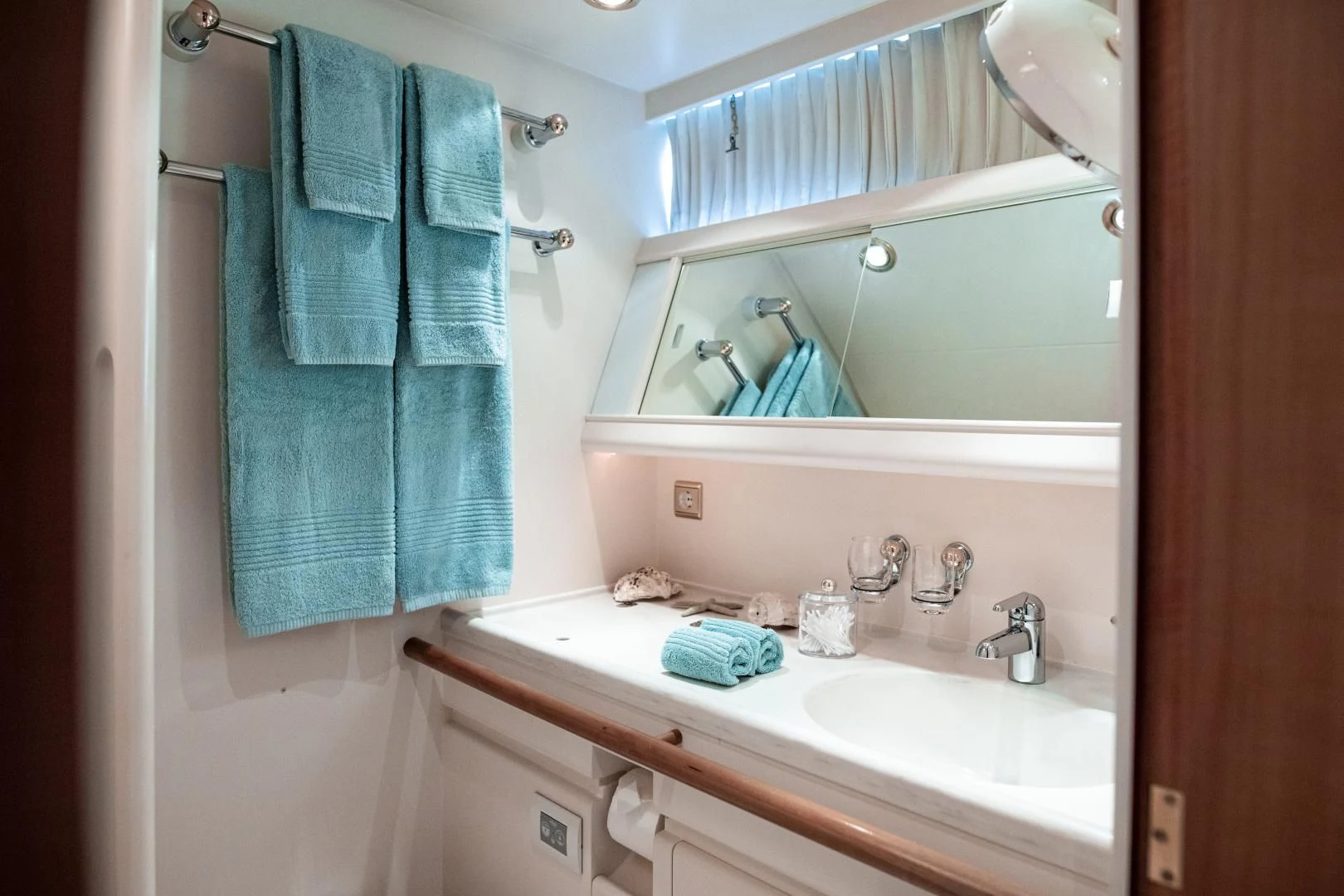 a bathroom with a sink and towels aboard SCARENA Yacht for Charter