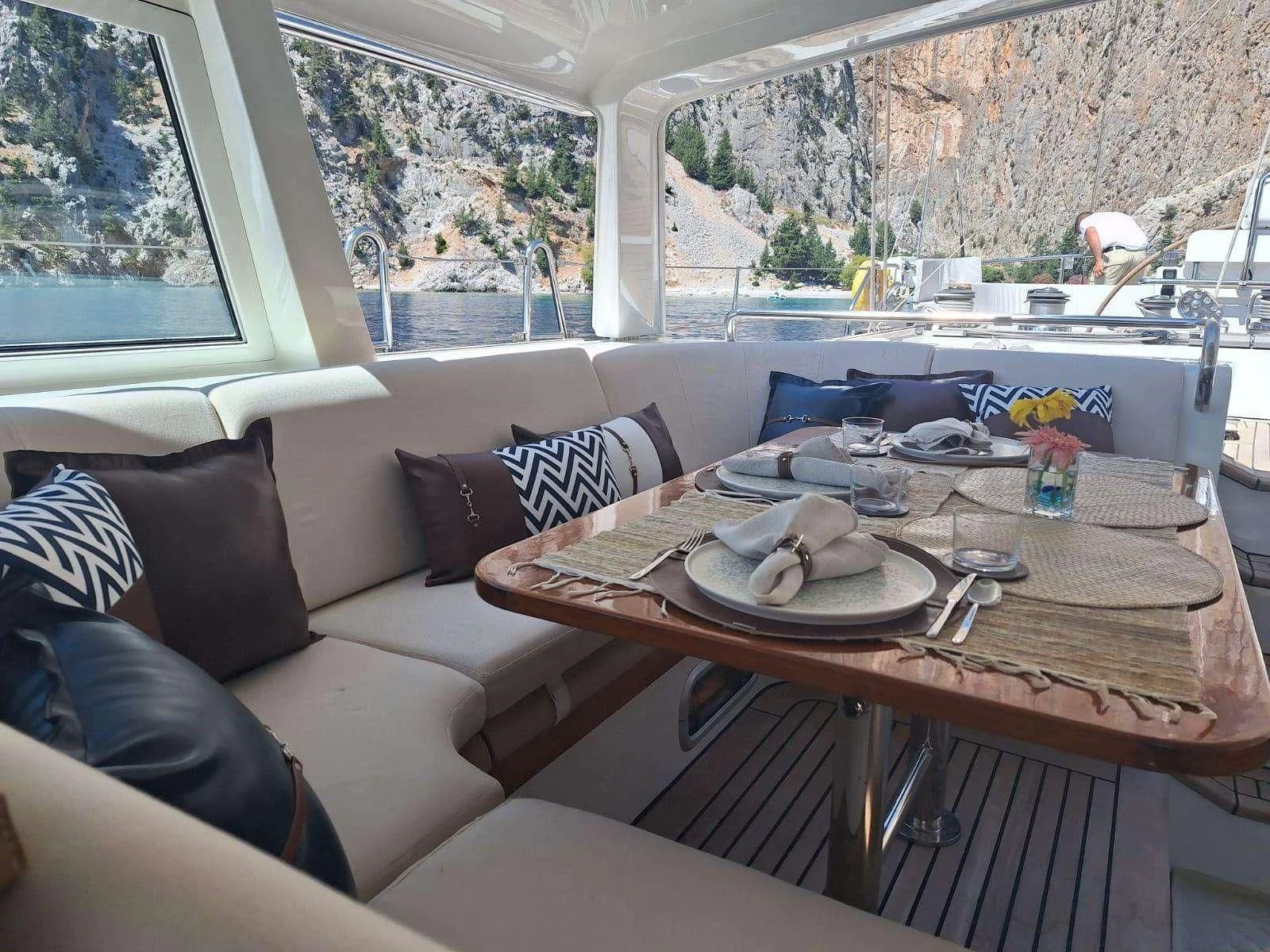 a table with plates and cups on it aboard SCARENA Yacht for Charter