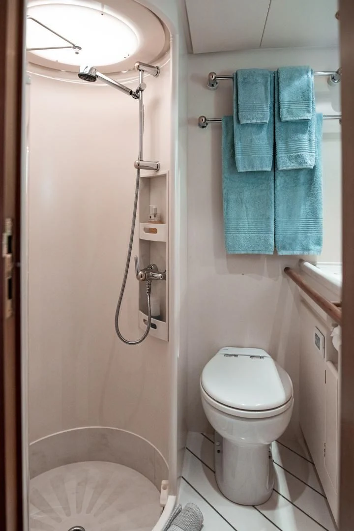 a bathroom with a toilet and a shower aboard SCARENA Yacht for Charter