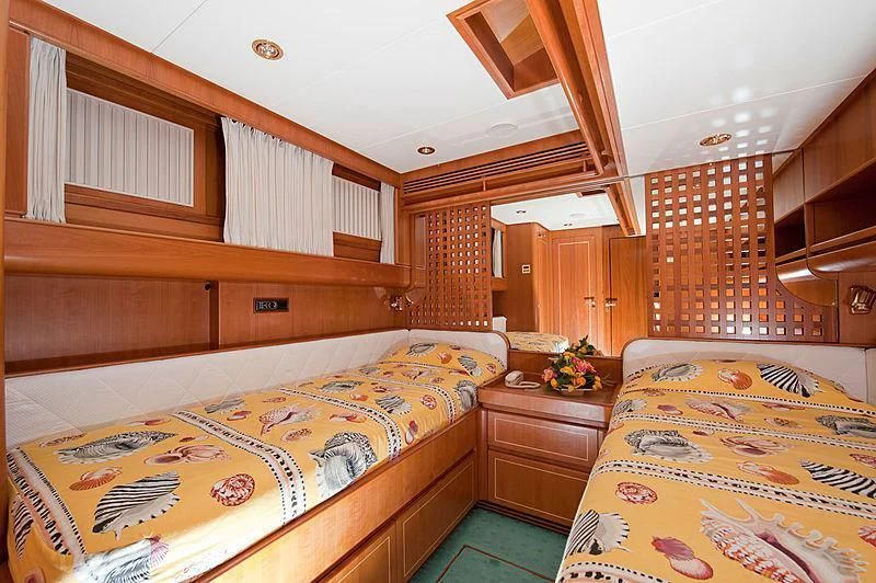 a bedroom with wood walls aboard SCARENA Yacht for Charter