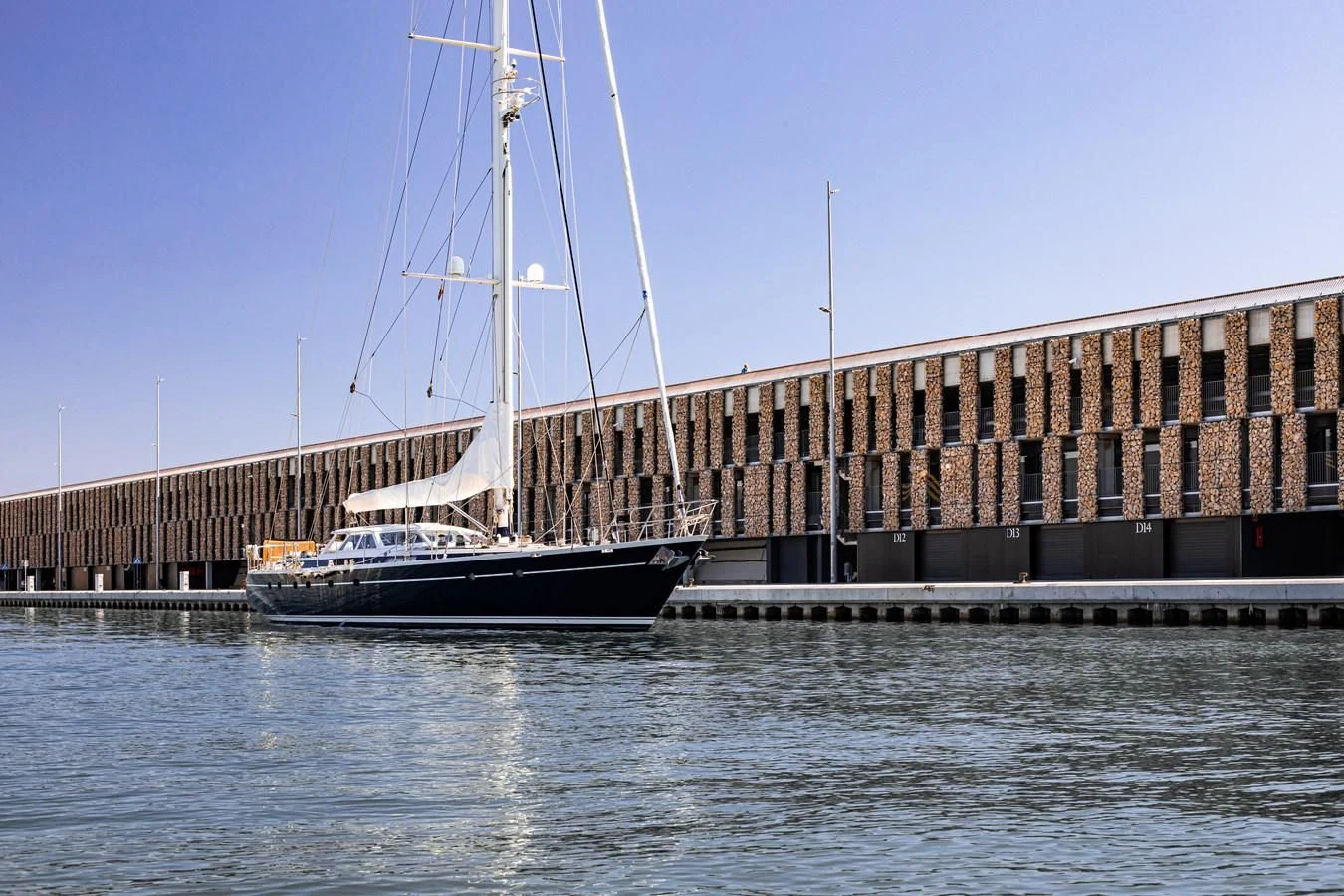 a boat docked in front of a large building aboard SCARENA Yacht for Charter