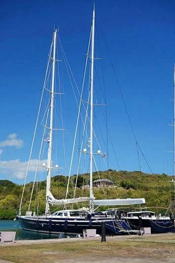 a sailboat docked at a pier aboard SCARENA Yacht for Charter